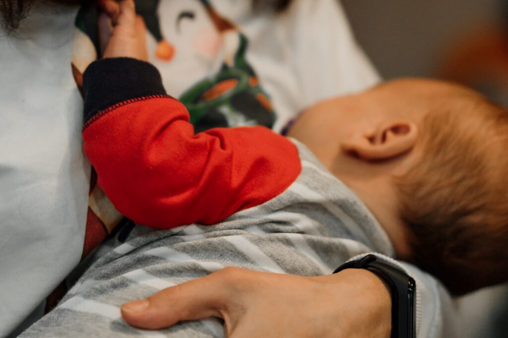 Mother holding baby in her arms Breastfeeding